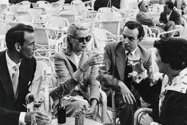 Grace Kelly with Gordon White (chairman of Hanson Industries) and Gladys de Ségonzac (a costume designer), on the terrace of the Carlton Cannes hotel at Cannes Film Festival, 1955