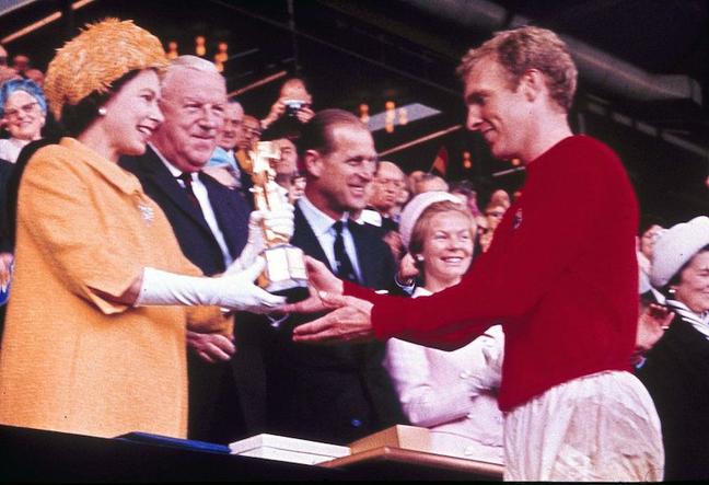 1966 - Queen Elizabeth presents England football captain Bobby Moore with the World Cup Trophy. (AP)
