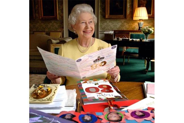 2006. The Queen, sitting in the Regency Room, looks at some of the birthday cards sent to her for her 80th Birthday. (Press Association)