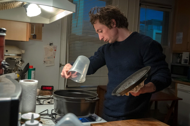 Carmen "Carmy" Berzatto in The Bear cooking at home.