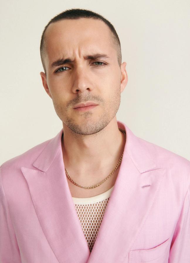 Jonah Hauer-King wearing a pink blazer over a white vest