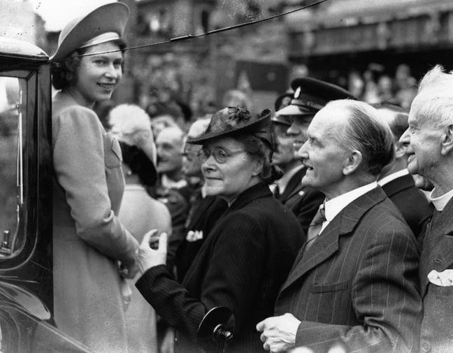 1945 - The Queen with members of the public in the East End of London. The date is 9th May 1945, the day after VE Day (Getty Images)