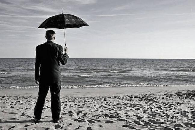 1-businessman-with-umbrella-on-beach-sami-sarkis