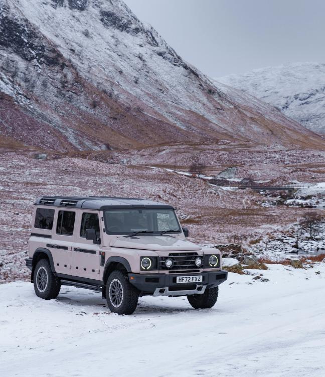 Ineos Grenadier driving over snowy terrain