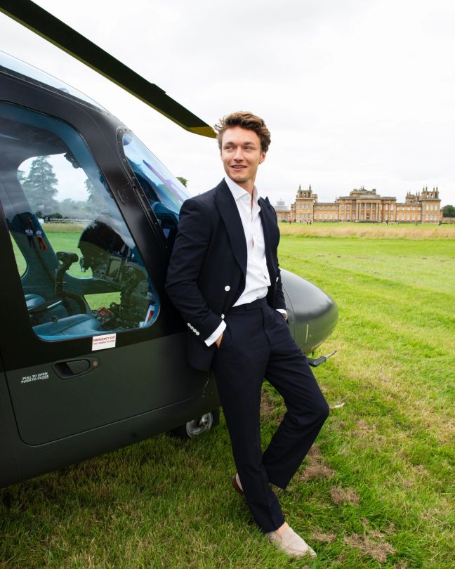 Harrison Osterfield leaning against a helicopter