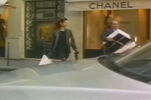 A still of a man and a woman walking towards a car from the 1996 film ‘Never Ever’