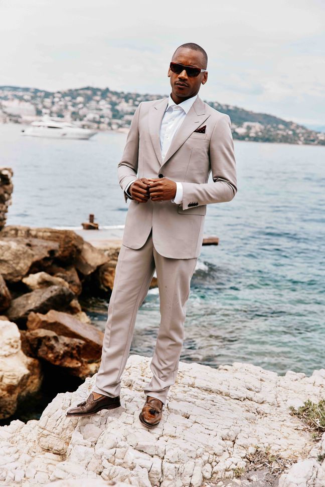 Eric Underwood standing on rocks along the Cannes sea front