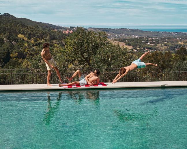 3 men on the pool side wearing Mr Marvis Shorts