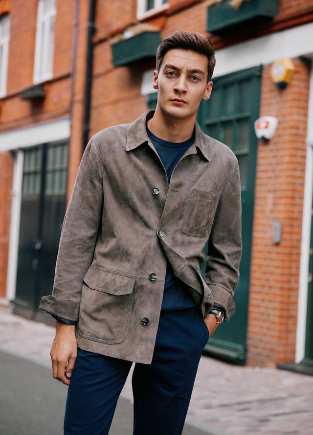 George Russell wears the IWC Portugieser Chronograph, Brioni Jacket, T-shirt by Sunspel, Trousers by Orlebar Brown and shoes by Tods