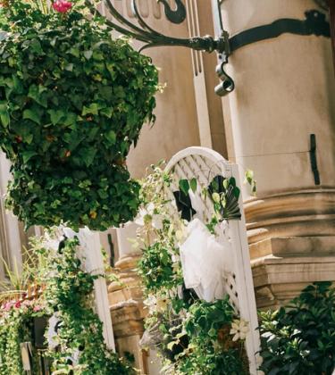 Model Kit Butler in a black suit walking out of a hotel lobby