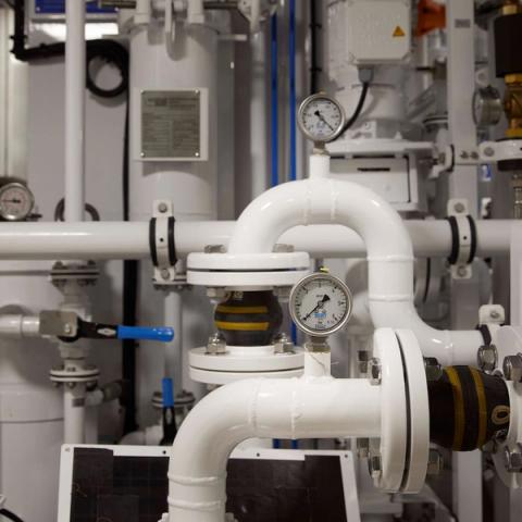 Pressure gauges and pipes system below deck on board Obsidian