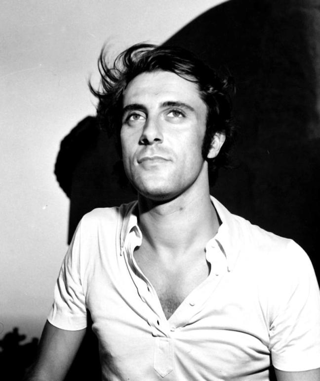 Black and White picture of Gig Rizzi in unbuttoned polo shirt