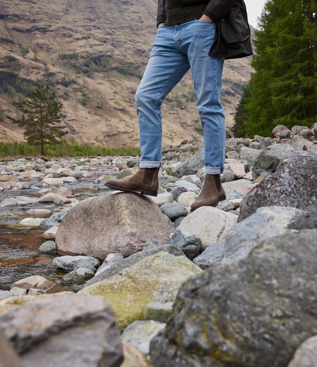 Man wearing Crockett & Jones Chelsea 5 shoes in Natural Rough-Out Suede around the Trossachs