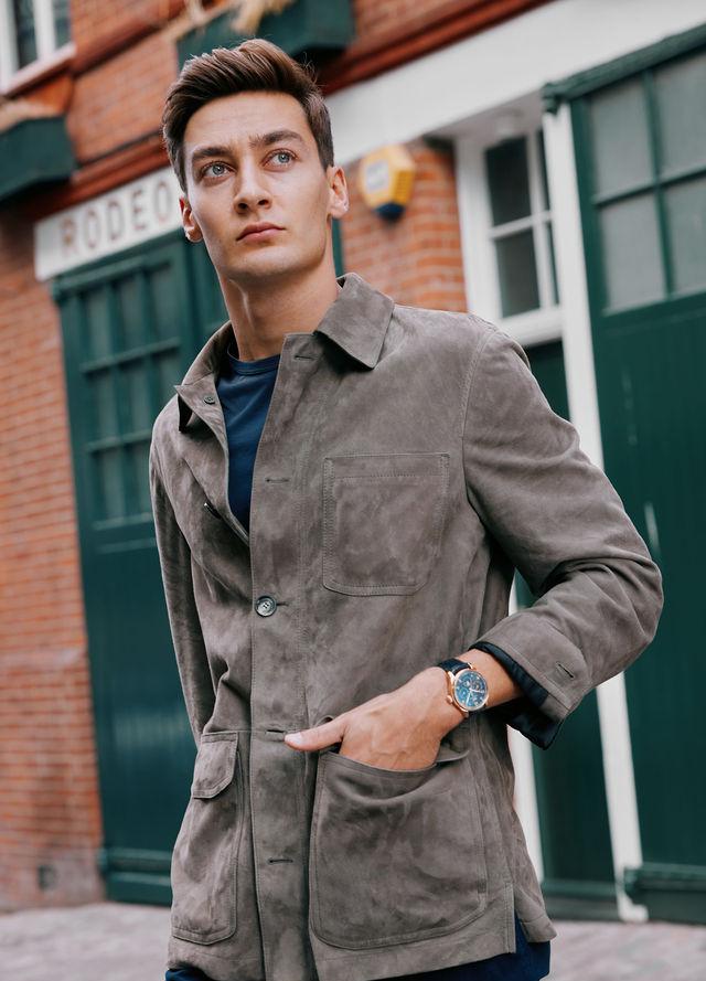 George Russell wears the IWC Portugieser Chronograph, Brioni Jacket, T-shirt by Sunspel, Trousers by Orlebar Brown and shoes by Tods