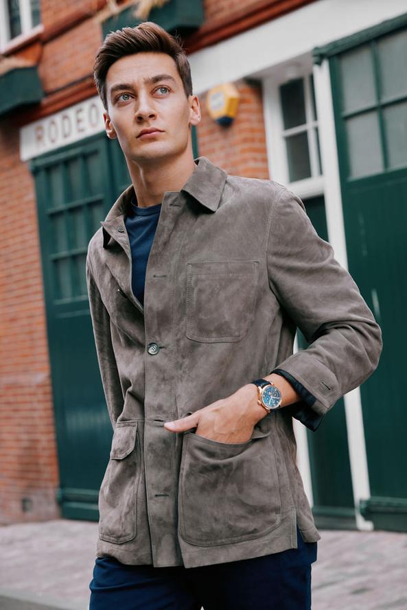 George Russell wears the IWC Portugieser Chronograph, Brioni Jacket, T-shirt by Sunspel, Trousers by Orlebar Brown and shoes by Tods