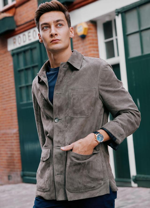 George Russell wears the IWC Portugieser Chronograph, Brioni Jacket, T-shirt by Sunspel, Trousers by Orlebar Brown and shoes by Tods