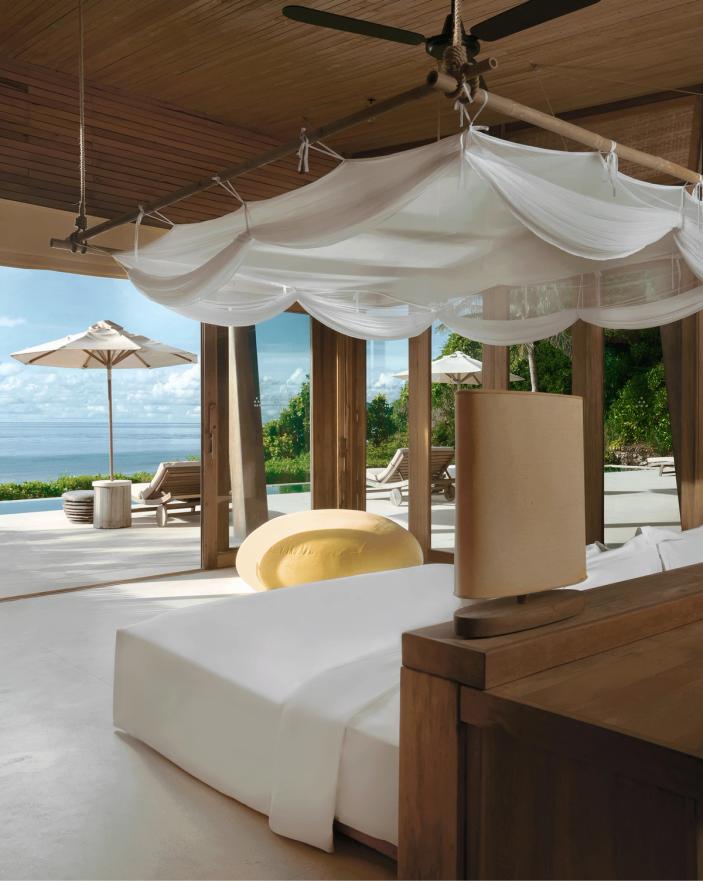 Canopied bedroom overlooking the sea at Six Senses Con Dao