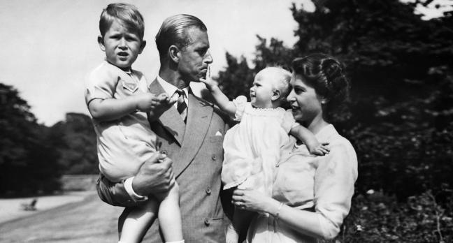 Prince Philip and Queen Elizabeth II with their children, Prince Charles and Princess Anne in July 1951 - Getty by Ullstein Bild