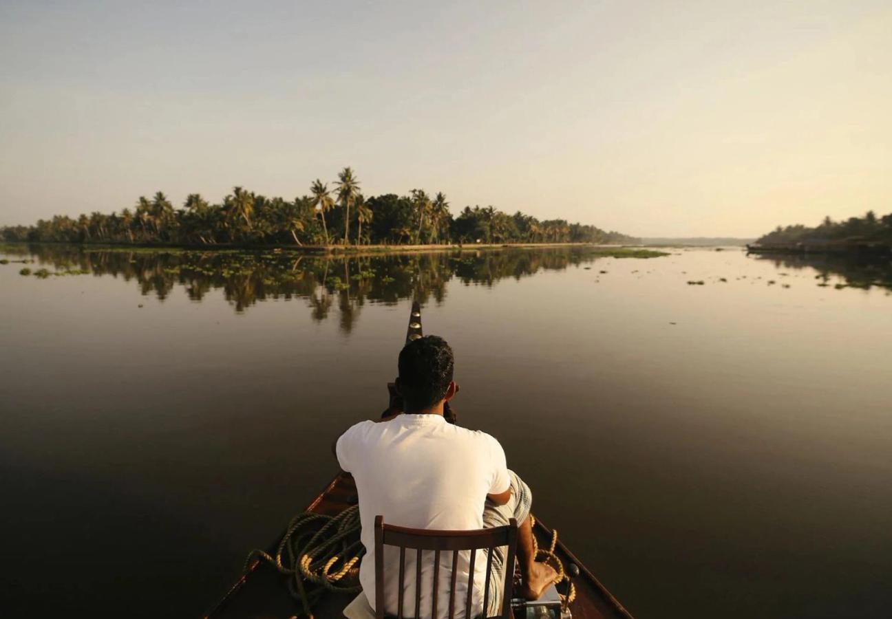 Man looking out on the river from a house boat in Kerala