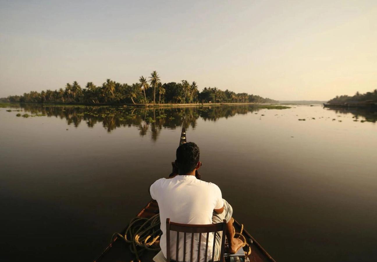 Man looking out on the river from a house boat in Kerala