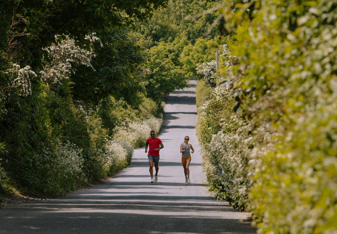 Two people running down a lane, for a Tracksmith campaign