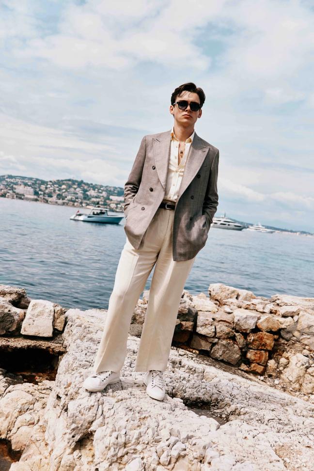 Mathias Le Fevre standing on rocks along the Cannes sea front