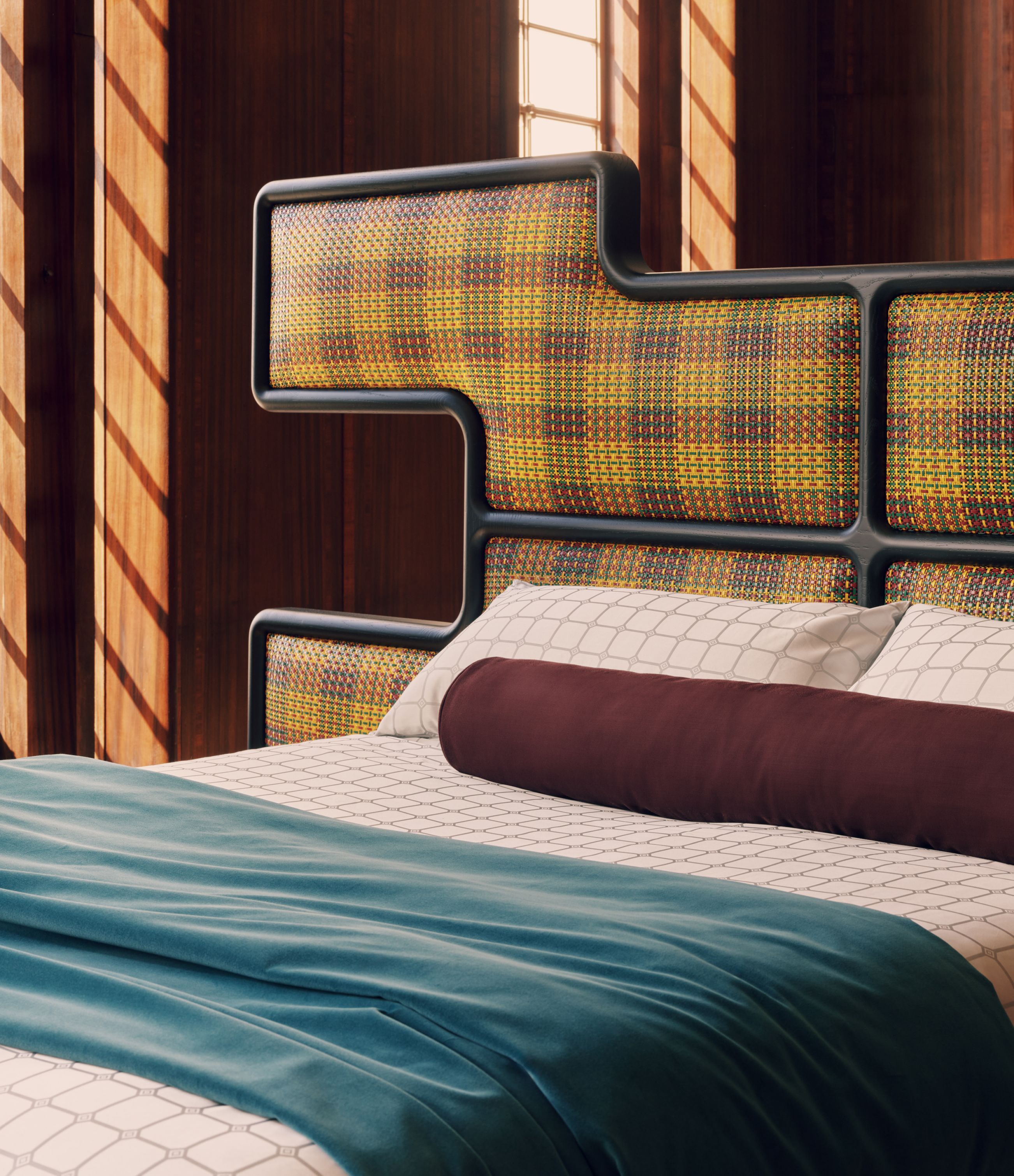 The patterned woven-leather headboard frames the Authenticity bed.