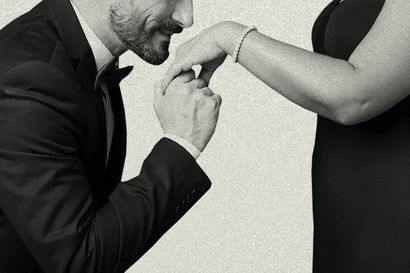a gentleman kneeling to kiss a woman's hand
