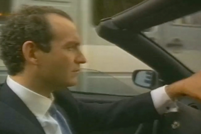 A still of a man in a car from the 1996 film ‘Never Ever’