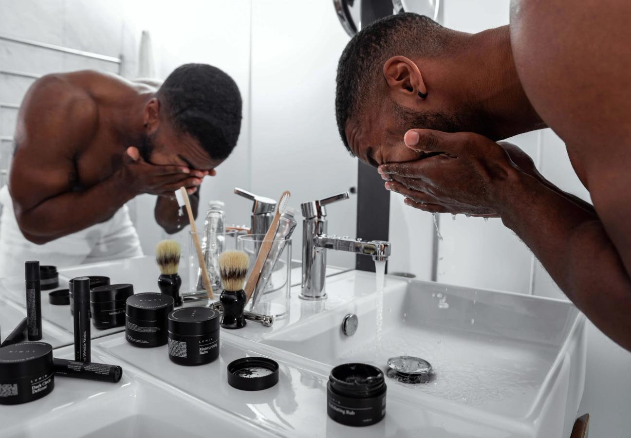 man washing face
