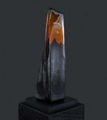 Bowmore 55-year-old Whisky in a glass bottle designed to resemble a rock formation
