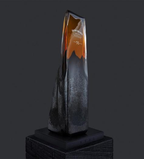 Bowmore 55-year-old Whisky in a glass bottle designed to resemble a rock formation