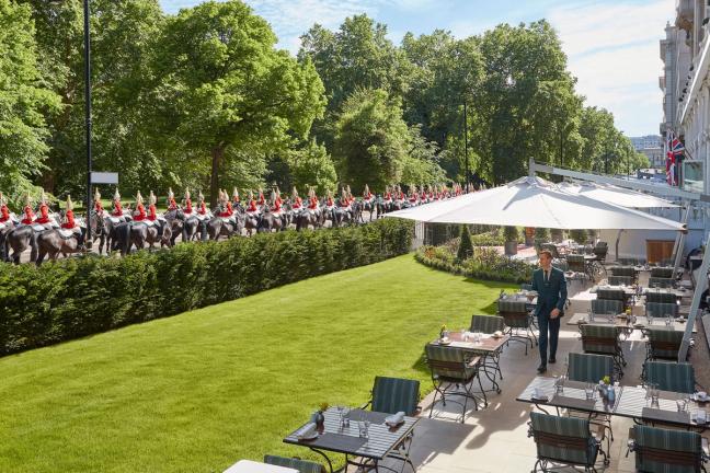 Mandarin Oriental garden with Horseguards walking through Hyde Park London