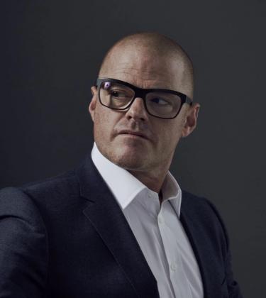 heston blumenthal wears glasses in a suit