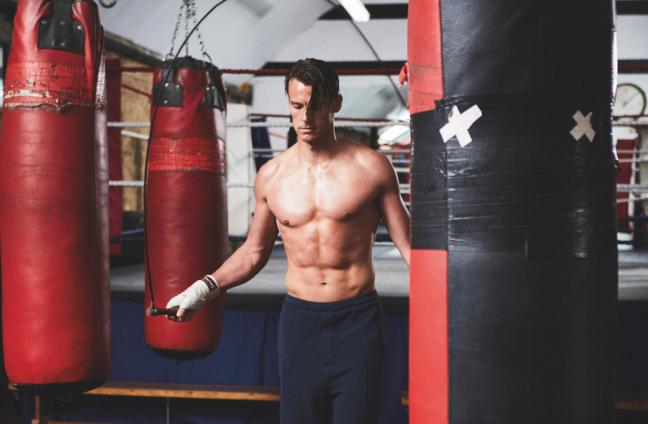Model uses skipping rope in boxing gym, photographed by Adam Fussell for Gentleman's Journal