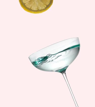 A Bottle of No. 3 London Dry Gin with a full martini glass and a slice of lemon