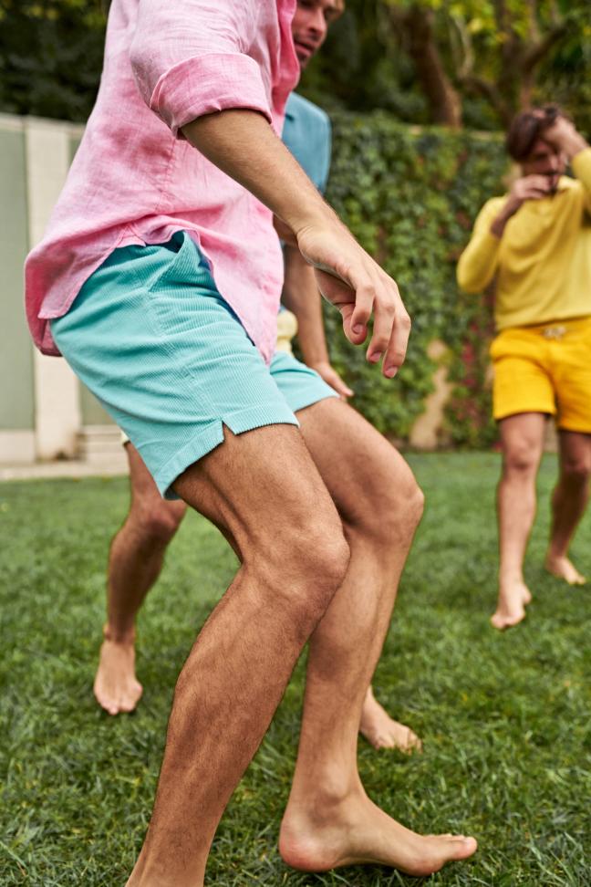Group of people playing outside wearing Mr Marvis shorts