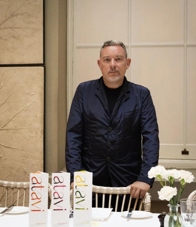 Chef Albert Adria standing in front of three boxes of pasta