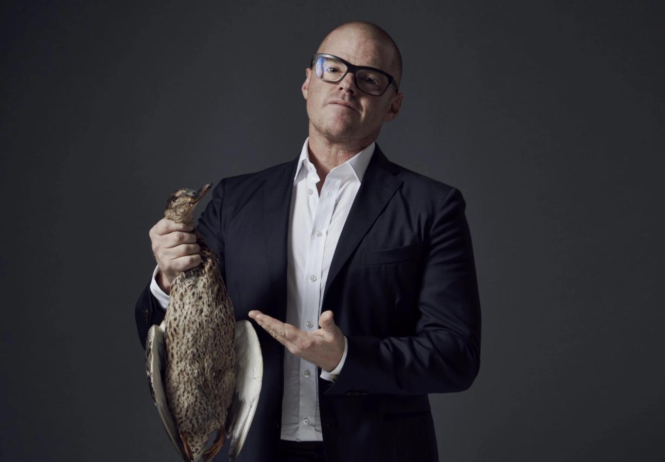 heston blumenthal wears glasses in a suit