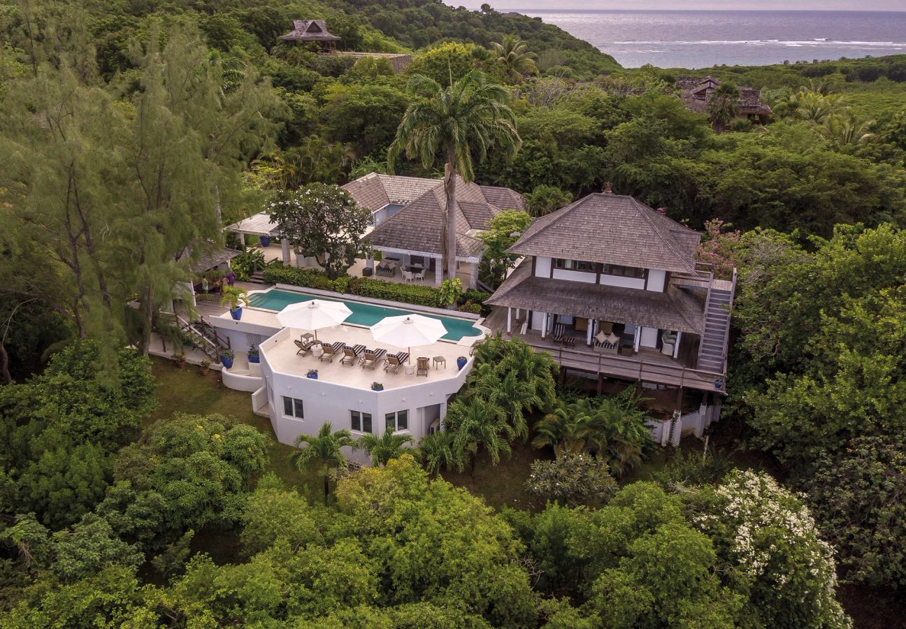 Balinese-style villa in the hills of Mustique surrounded by trees with far-reaching sea views