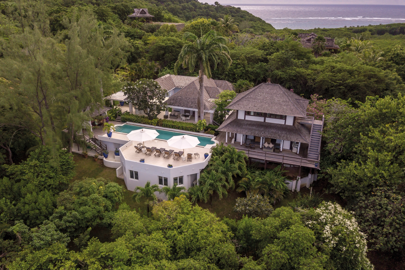 Balinese-style villa in the hills of Mustique surrounded by trees with far-reaching sea views