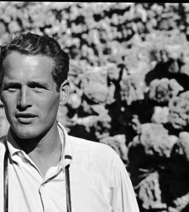 black and white photo of actor Paul Newman wearing a white shirt