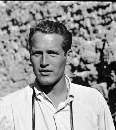 black and white photo of actor Paul Newman wearing a white shirt