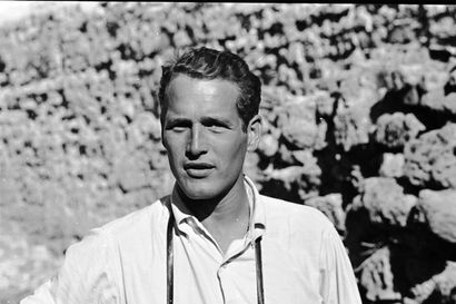 black and white photo of actor Paul Newman wearing a white shirt