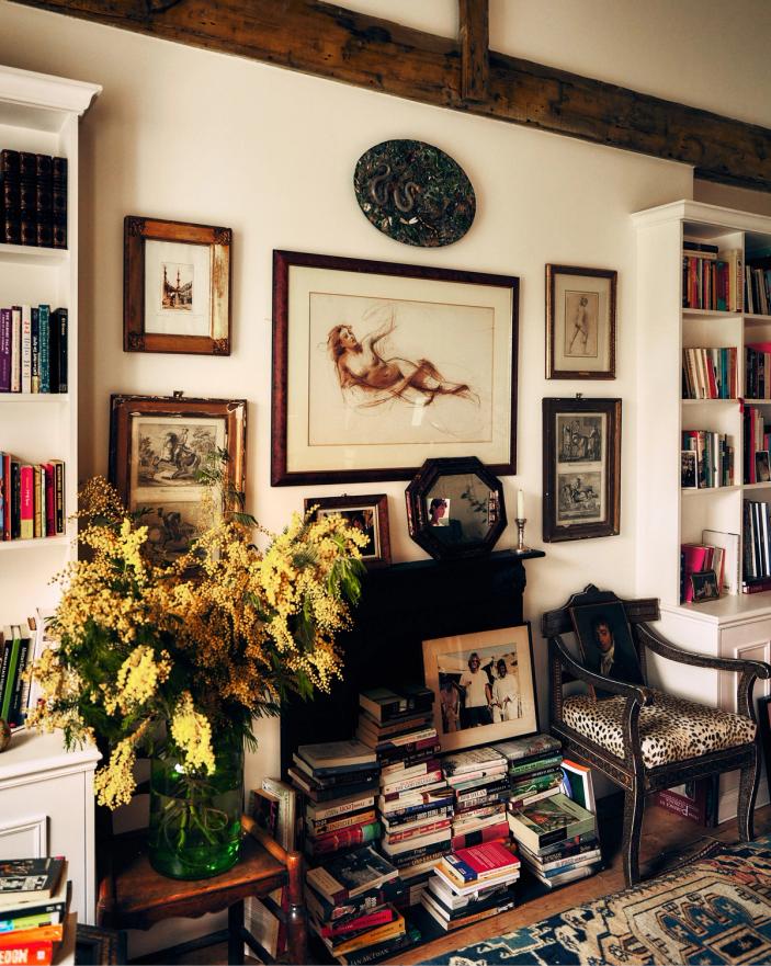 Framed pictures, books and flowers in Jamie Sharp’s living room