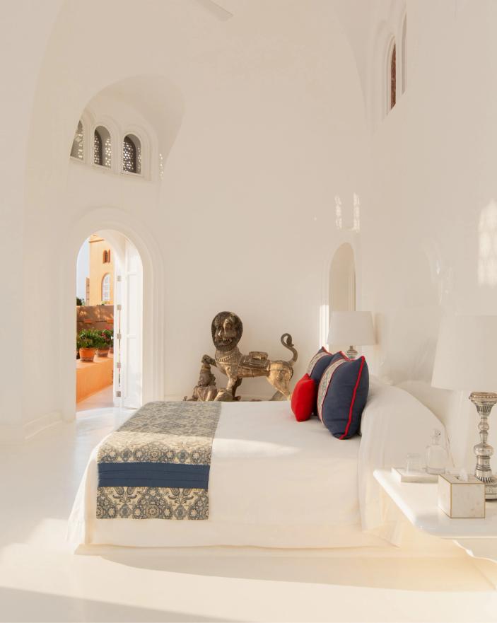 Whitewashed interior and colourful cushions at Cuixmala