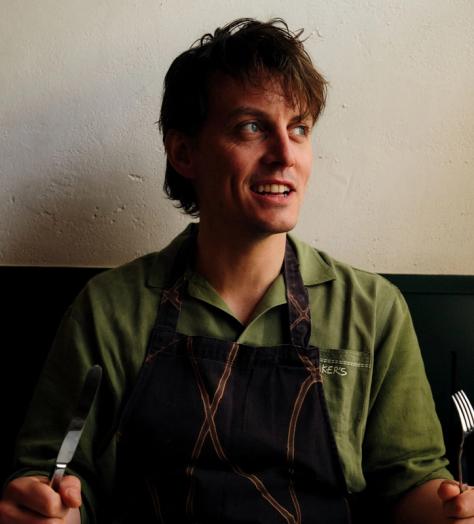 Tom Straker holing a knife and fork