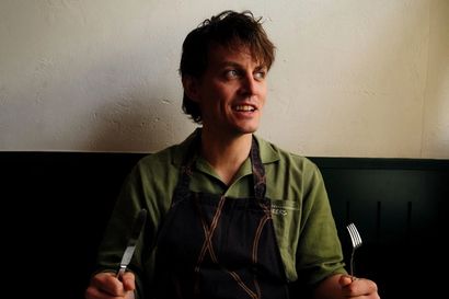 Tom Straker holing a knife and fork