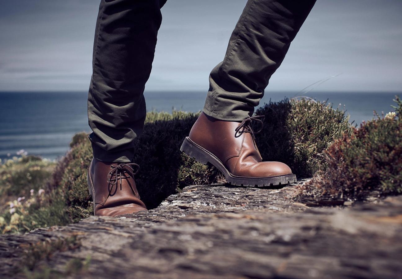 Man wearing Crockett & Jones’s Teak Oiled Side chukka boot out in the countryside hills
