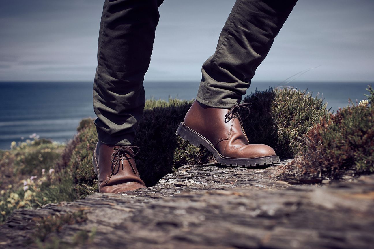 Man wearing Crockett & Jones’s Teak Oiled Side chukka boot out in the countryside hills